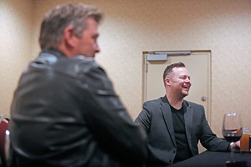 Doc Walker singer and guitarist Dave Wasyliw has a laugh with fellow musician Chris Thorsteinson, band tour manager Ian Leary and Thorsteinson's wife Sonya Thorsteinson (both off camera), while chilling out in a room at the Victoria Inn, prior to the band's special accoustic performance at the Provincial Exhibition of Manitoba's President's Dinner at the Victoria Inn on Thursday evening. (Matt Goerzen/The Brandon Sun)