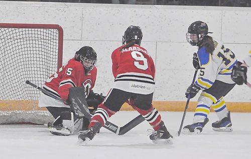Westman Wildcats forward Ivy Perkin (15), the U18 AAA Manitoba Female Hockey League rookie of the year, looks for a rebound in front of Pembina Valley Hawks goalie Kasia Rakowski, with help from her rearguard Leah Klaaseen (9) during first period action on Sunday in Harney. After 20 minutes, the teams were knotted at 1-1 in Game 3, with the Wildcats up 2-0 in the best-of-five quarterfinal series. (Jules Xavier/The Brandon Sun)