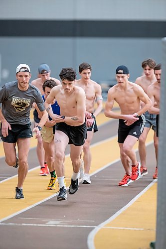 BROOK JONES / WINNIPEG FREE PRESS
University of Manitoba Bisons men's track &amp; field team middle distance runners Calvin Reimer (far left) and Noel Kendle (second from far left) train on the track at the James Daly Fieldhouse at the University of Manitoba Fort Garry campus in Winnipeg, Man., Tuesday, Feb. 27, 2024. The Bisons men's team captured the Canada West Track &amp; Field Championships for the third year in a row. Reimer will be competing at the upcoming U Sports Track &amp; Field Championships for his third year in a row and Kendle will be competing for this fourth year in a row.