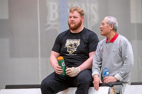 BROOK JONES / WINNIPEG FREE PRESS
University of Manitoba Bisons men's track &amp; field team weight thrower Graham Wright (left) chats with Bisons assistant coach Mingpu Wu during a training training session at the James Daly Fieldhouse at the University of Manitoba Fort Garry campus in Winnipeg, Man., Tuesday, Feb. 27, 2024. The Bisons men's team captured the Canada West Track &amp; Field Championships for the third year in a row. Wright will be competing at the upcoming U Sports Track &amp; Field Championships in Winnipeg March 7 to 9, 2024.