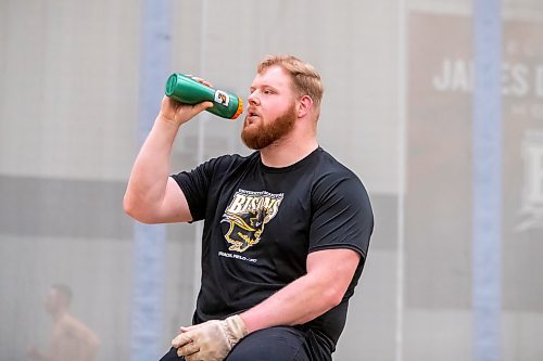 BROOK JONES / WINNIPEG FREE PRESS
University of Manitoba Bisons men's track &amp; field team weight thrower Graham Wright takes a sip of water while training at the James Daly Fieldhouse at the University of Manitoba Fort Garry campus in Winnipeg, Man., Tuesday, Feb. 27, 2024. The Bisons men's team captured the Canada West Track &amp; Field Championships for the third year in a row. Wright will be competing at the upcoming U Sports Track &amp; Field Championships in Winnipeg March 7 to 9, 2024.