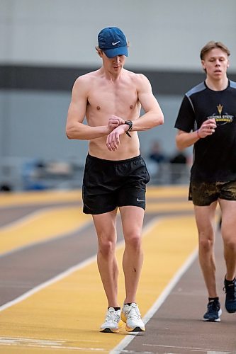 BROOK JONES / WINNIPEG FREE PRESS
University of Manitoba Bisons men's track &amp; field team middle distance runners Tristan Allen (left) checks his wrist watch while training with his brother Keena Allen at the James Daly Fieldhouse at the University of Manitoba Fort Garry campus in Winnipeg, Man., Tuesday, Feb. 27, 2024. The Bisons men's team captured the Canada West Track &amp; Field Championships for the third year in a row. Tristan Allen and his younger brother Keenan Allen will be competing at the upcoming U Sports Track &amp; Field Championships in Winnipeg March 7 to 9, 2024.