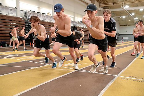 BROOK JONES / WINNIPEG FREE PRESS
University of Manitoba Bisons men's track &amp; field team middle and long distance runners Alejandro Civetta (far left), Tristan Allen (second from far left), Dawson Mann (right) and Keenan Allen (back right) train on the track at the James Daly Fieldhouse at the University of Manitoba Fort Garry campus in Winnipeg, Man., Tuesday, Feb. 27, 2024. The Bisons men's team captured the Canada West Track &amp; Field Championships for the third year in a row.
