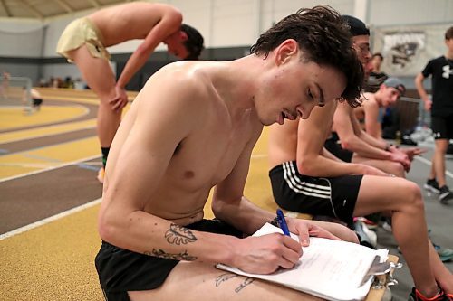 BROOK JONES / WINNIPEG FREE PRESS
University of Manitoba Bisons men's track &amp; field team middle distance runner Noel Kendle writes down his time for a running interview for Bisons head coach Claude Berube while training at the James Daly Fieldhouse at the University of Manitoba Fort Garry campus in Winnipeg, Man., Tuesday, Feb. 27, 2024. The Bisons men's team captured the Canada West Track &amp; Field Championships for the third year in a row. Kendle will be competing at the upcoming U Sports Track &amp; Field Championships this fourth year in a row.