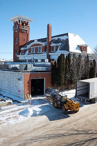 A forklift owned by Ben Wiebe Construction unloads brewing equipment into a garage on the north side of Brandon's historic fire hall on Princess Avenue. The fire hall has been sold to new owners, who are storing the equipment there temporarily. (Matt Goerzen/The Brandon Sun)