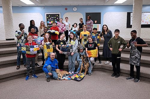 Students with Riverheights School teacher Celine Cramer's home economics course pose for a group photo after listening to a presentation from the Brandon Humane Society on Wednesday morning. The class presented the Humane Society with 11 dog blankets that were crafted this year and last year using leftover cloth from student course work. (Matt Goerzen/The Brandon Sun)