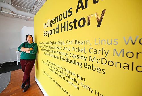 Brandon University assistant professor and art history instructor, Dr. Stacey Koosel, stands beside the sign advertising the latest exhibit, Indigenous Art: Beyond History, at the Glen P. Sutherland Gallery of Art on Thursday afternoon. The exhibit opens to the public tonight between 7-9 p.m. and will be on display until March 15. (Matt Goerzen/The Brandon Sun)