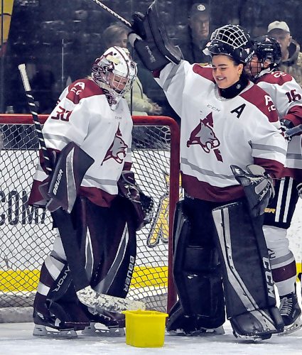 Senior Assiniboine Community College Cougars goalie Geneva Penner (35) wish her goaltending partner Payton Murray (30) prior to her start at J&G Homes Arena. (Jules Xavier/The Brandon Sun)