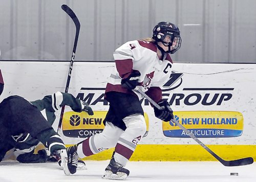 Assiniboine Community College Cougars co-captain Jensen Shearer (9) moves the puck forward after a battle along the wall with an opponent during a recent game at J&G Homes Arena. (Jules Xavier/The Brandon Sun)