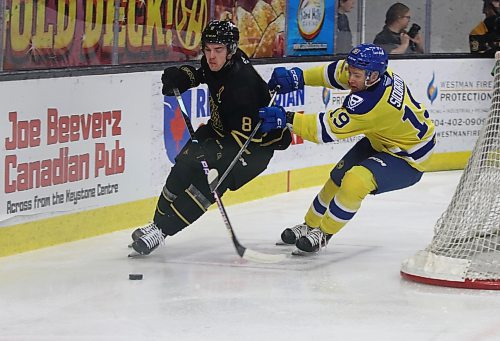 Brandon Wheat Kings defenceman Quinn Mantei (8) and Saskatoon Blades forward Egor Sidorov pursue the puck behind the Brandon net during Western Hockey League action at Westoba Place on Saturday. (Perry Bergson/The Brandon Sun)