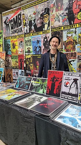 Winnipeg artist GMB Chomichuk with his posters and comic books at the Westman Gaming Expo, held at the Keystone Centre in Brandon on the weekend. (Miranda Leybourne/The Brandon Sun)