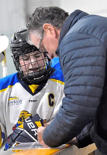 Westman Wildcats coach Tony Franklin goes over strategy with captain Kelsey Huibers at the bench during a break in action in Hartney during the opening round of the U18 AAA Manitoba Female Hockey League playoffs. (Jules Xavier/The Brandon Sun)