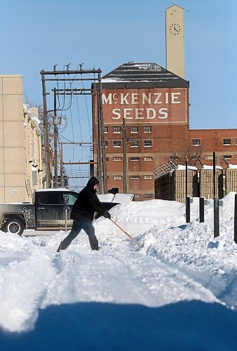 A man shovels a backlane driveway on Monday morning south of the old McKenzie Seeds building downtown. (Matt Goerzen/The Brandon Sun)