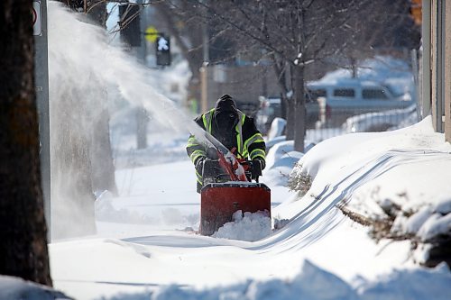 A man with a snowblower cleans the sidewalk along 10th Street, north of Victoria Avenue on Monday morning. (Matt Goerzen/The Brandon Sun)