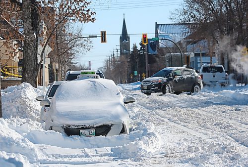 A taxi lies buried beneath a snowdrift along Lorne Avenue, one of the many vehicles that were left along the roadsides on Monday following an overnight blizzard that dumped nearly 30 centimetres of snow on the city of Brandon. (Matt Goerzen/The Brandon Sun)