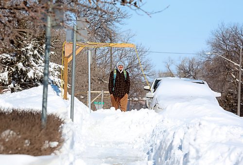 A pedestrian walks a snowpacked sidewalk along Dennis Street on Monday afternoon. (Matt Goerzen/The Brandon Sun)