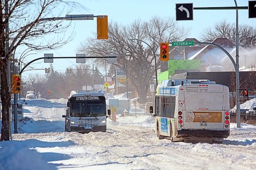 A pair of City of Brandon Transit buses cross Victoria Avenue at 10th Street on Monday morning, after a blizzard blanketed the city with snow overnight. (Matt Goerzen/The Brandon Sun)