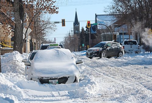 A taxi lies buried beneath a snowdrift along Lorne Avenue, one of the many vehicles that were left along the roadsides on Monday following a weekend blizzard that dumped nearly 30 cm of snow on the city of Brandon. (Matt Goerzen/The Brandon Sun)