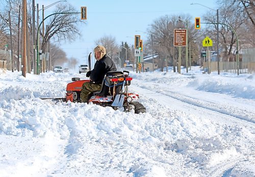 A Brandon homeowner along Victoria Avenue opposite the Brandon Regional Health Centre operates a garden tractor snowplow in his front entrance on Monday afternoon, following a weekend blizzard that dumped nearly 30 cm of snow on the city. (Matt Goerzen/The Brandon Sun)