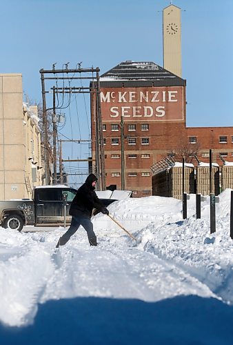 A man shovels a backlane driveway on Monday morning south of the old McKenzie Seeds building downtown, following a weekend blizzard that Environment Canada says dropped nearly 30 cm of snow on the city. (Matt Goerzen/The Brandon Sun)