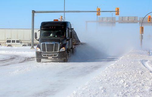 Flying snow follows an eastbound semi truck a the First Street junction with the Trans-Canada Highway on Monday afternoon. Heavy winds made visibility difficult on the highways outside of the city of Brandon. (Matt Goerzen/The Brandon Sun)