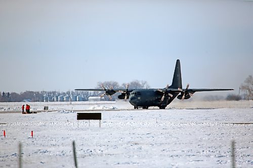 A military parachute team waits on the ground at the Brandon Municipal Airport while a C-130 Hercules aircraft taxis on the tarmack during a routine training session. (Matt Goerzen/The Brandon Sun)