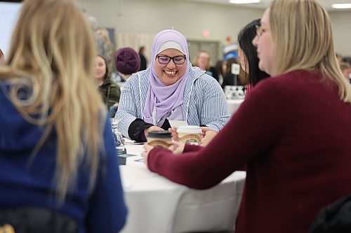 Elda Colores from Westman Immigrant Services shares a laugh with her co-workers during the conference. (Michele McDougall/The Brandon Sun)
