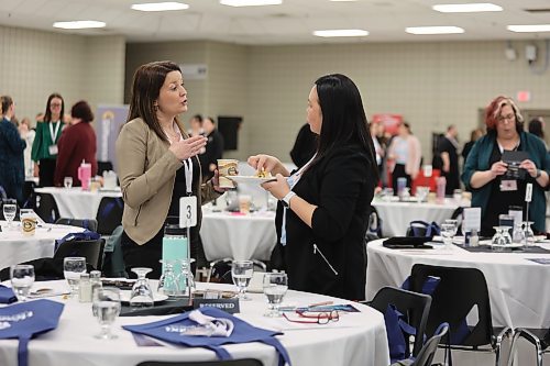 Two women talk in between speakers during the Women of Westman Conference hosted by Brandon Chamber of Commerce at the Keystone Centre on Wednesday. (Michele McDougall/The Brandon Sun)
