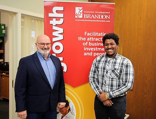 Brandon's director of economic development, Gerald Cathcart (left), and immigration specialist Samuel Soloman (right) stand inside their office on the first floor of Brandon City Hall on Thursday. (Colin Slark/The Brandon Sun)