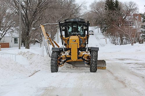 A grader pushes snow off of a street in the east end on Thursday. Brandon was forced to dig out once again after 16 centimetres of snow fell the previous night. (Colin Slark/The Brandon Sun)
