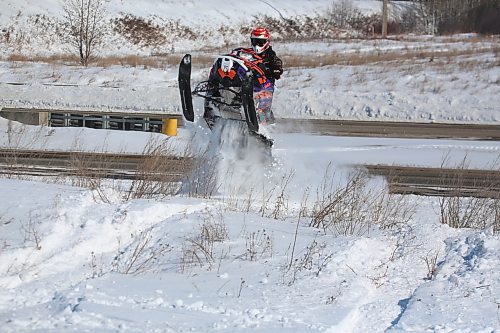 One of a pair of snowmobilers enjoys the soft snow of a drift along the ditch near Highway 110 under blue skies on a sunny Friday afternoon. (Matt Goerzen/The Brandon Sun)