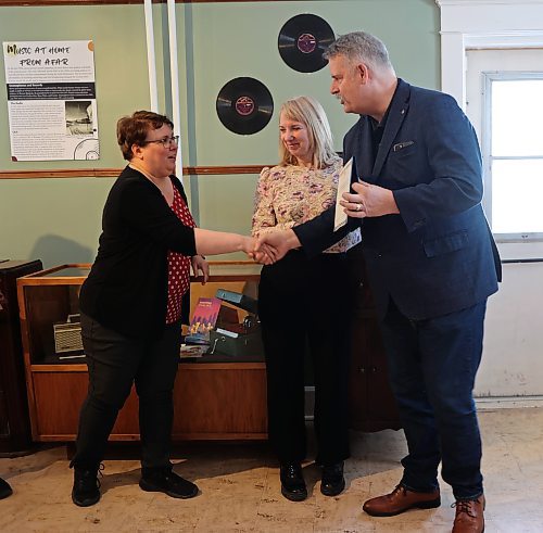 Brandon West MLA Wayne Balcaen presented the Daly House Museum with a certificate congratulating them for their newest exhibit, "The Sound of History," at the exhibit's grand opening on Saturday. (Geena Mortfield/The Brandon Sun)