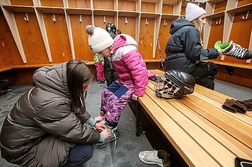 JOHN WOODS / FREE PRESS
Recent immigrant from Ukraine Oksana Sukhar ties her daughter, Sofiia&#x2019;s, skates before they practise their skating at the True North Foundation&#x2019;s Welcome to Winnipeg event at Camp Morton Sunday, March 10, 2024. About 150 children from new immigrant families had the chance to try out various winter activities such as snowshoeing, cross-country skiing, skating and hockey.

Reporter: ?