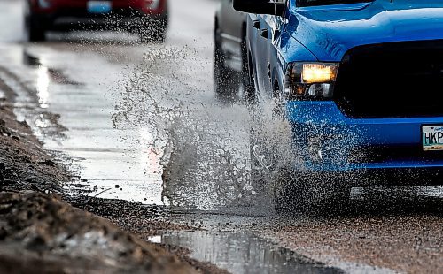 JOHN WOODS / FREE PRESS
Driver hits a submerged potholes on Archibald Monday, March 11, 2024. 

Reporter: ?