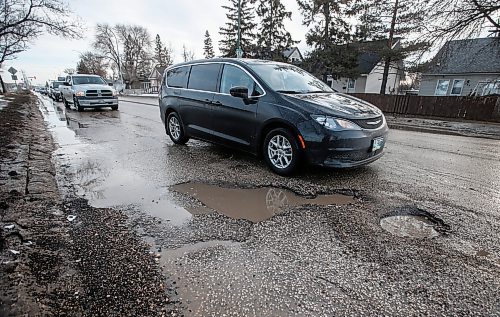 JOHN WOODS / FREE PRESS
Drivers slow down to try and avoid submerged potholes on Archibald Monday, March 11, 2024. 

Reporter: ?