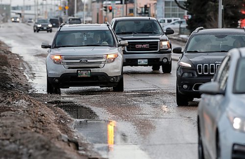 JOHN WOODS / FREE PRESS
Drivers slow down to try and avoid submerged potholes on Archibald Monday, March 11, 2024. 

Reporter: ?