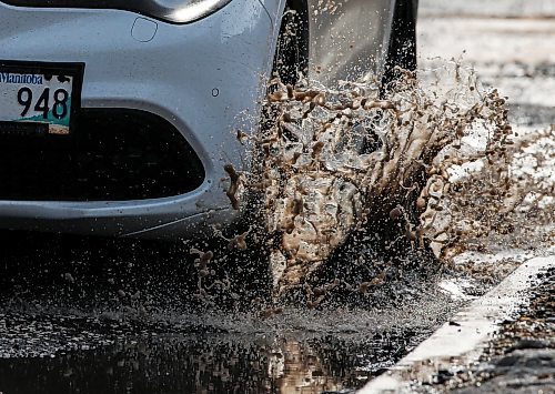 JOHN WOODS / FREE PRESS
Driver hits a submerged potholes on Stradbrook Monday, March 11, 2024. 

Reporter: ?