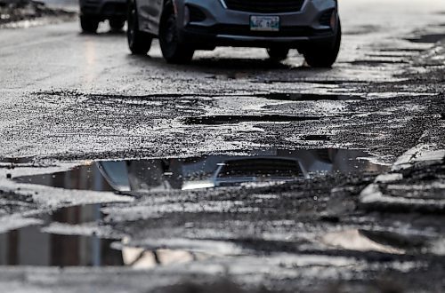 JOHN WOODS / FREE PRESS
drivers try to avoid submerged potholes on Stradbrook Monday, March 11, 2024. 

Reporter: ?