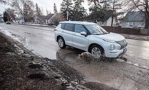 JOHN WOODS / FREE PRESS
Driver hits a submerged potholes on Archibald Monday, March 11, 2024. 

Reporter: ?