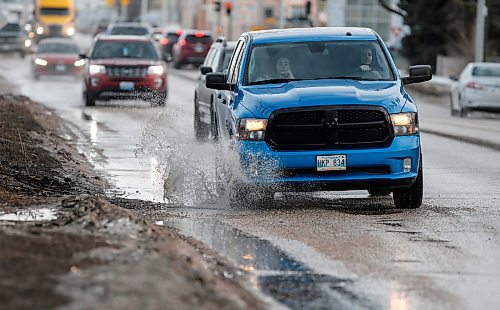 JOHN WOODS / FREE PRESS
Driver hits a submerged potholes on Archibald Monday, March 11, 2024. 

Reporter: ?