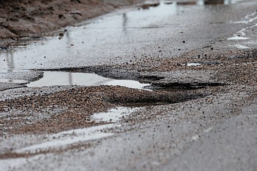 JOHN WOODS / FREE PRESS
Drivers try to avoid submerged potholes on Archibald Monday, March 11, 2024. 

Reporter: ?