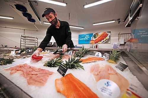 A Sobeys West employee readies a customer purchase from the newly renovated seafood display. (Matt Goerzen/The Brandon Sun)