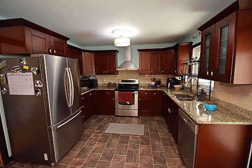 Photos by Todd Lewys / Winnipeg Free Press
The fresh kitchen offers cherry cabinets, granite countertops, a tile backsplash and newer stainless appliances.