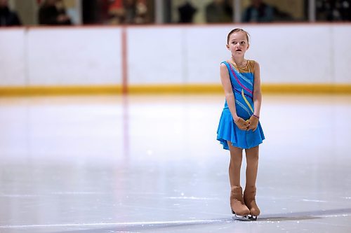 A young girl in the Pre Star category waits for other skaters to join her on the ice for the first skate of the evening. (Matt Goerzen/The Brandon Sun)