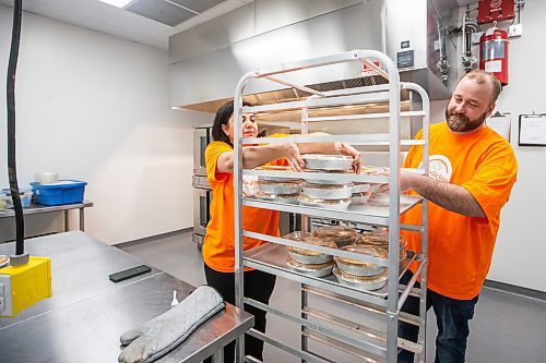 MIKAELA MACKENZIE / FREE PRESS

Marli Cordella (left) and Giuliano Roveri, owners of Brazilicious, load freshly made chicken pies onto a rack in their commercial kitchen in Winnipeg on Wednesday, March 13, 2024.  They both hail from Sao Paulo, Brazil, and started a food biz in November offering a taste of home.

For Dave Sanderson story.