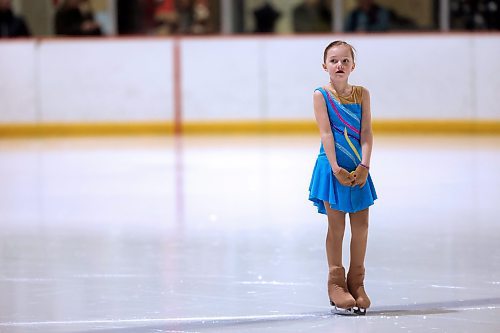 A young girl in the Pre Star category waits for other skaters to join her on the ice for the first skate of the evening on Tuesday, in Skate Brandon's last performance of the season at Flynn Arena. (Matt Goerzen/The Brandon Sun)