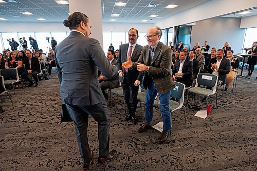 MIKE DEAL / WINNIPEG FREE PRESS
Manitoba Premier, Wab Kinew, shakes hands with Wawanesa's CEO, Jeff Goy (centre), as well as the CEO of True North Real Estate Development, Jim Ludlow (right) during the opening of the new Wawanesa Insurance headquarters at 236 Carlton St., at True North Square, in downtown Winnipeg, Wednesday morning.
240313 - Wednesday, March 13, 2024.