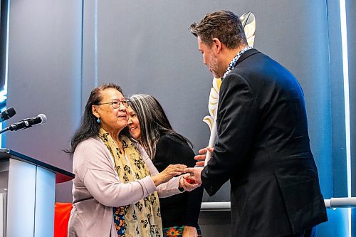 MIKAELA MACKENZIE / FREE PRESS

Elder Florence Paynter hands Winnipeg Foundation CEO Sky Bridges a gift of an eagle feather carving after he announced five million in funding for the National Centre for Truth and Reconciliation in Winnipeg on Thursday, March 14, 2024.  

For Malak story.