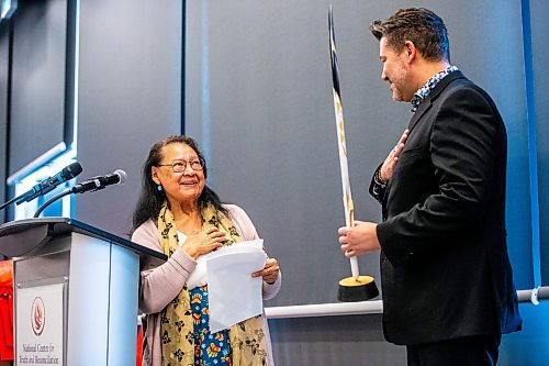 MIKAELA MACKENZIE / FREE PRESS

Elder Florence Paynter hands Winnipeg Foundation CEO Sky Bridges a gift of an eagle feather carving after he announced five million in funding for the National Centre for Truth and Reconciliation in Winnipeg on Thursday, March 14, 2024.  

For Malak story.