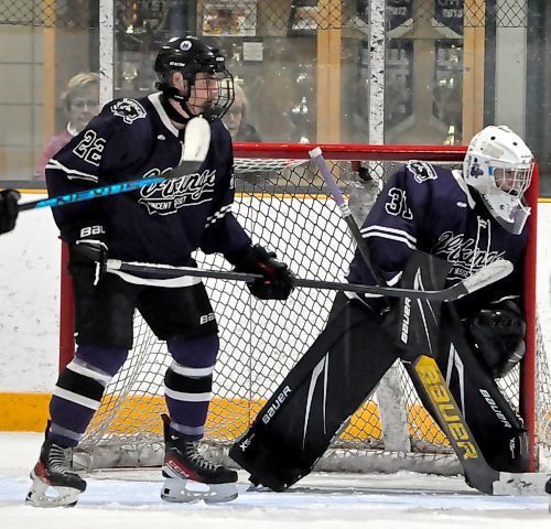 With defenceman Landen Dreolini (22) watches in front of the crease, Vincent Massey goalie Sawyer Wallin (31) hugs his post while watching the action in the corner during a game at Flynn Arena. (Jules Xavier/The Brandon Sun)